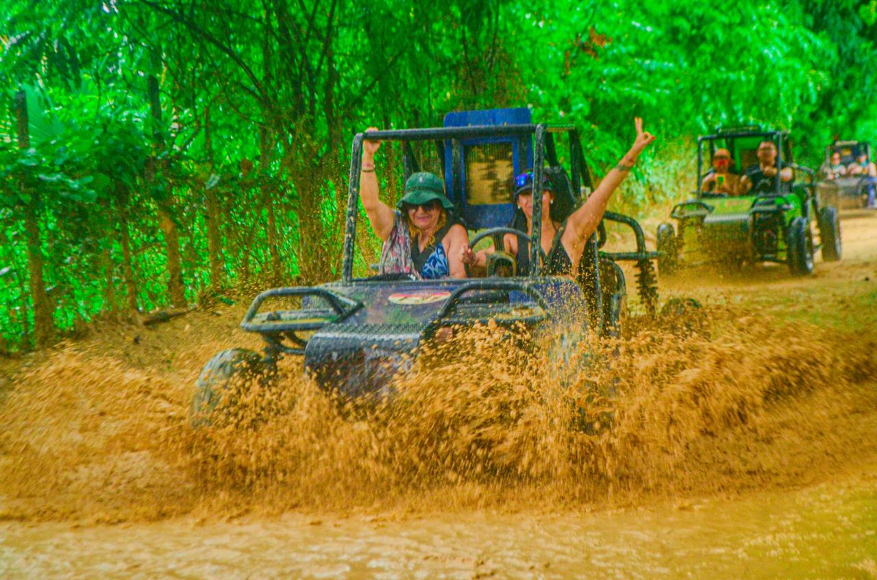 Off-road buggy moving through a muddy trail
